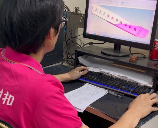 NAIKLE team member working on product design at a computer