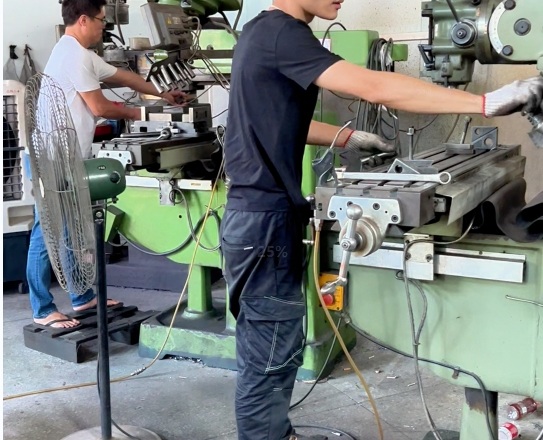 Worker operating machinery in NAIKLE tooling workshop